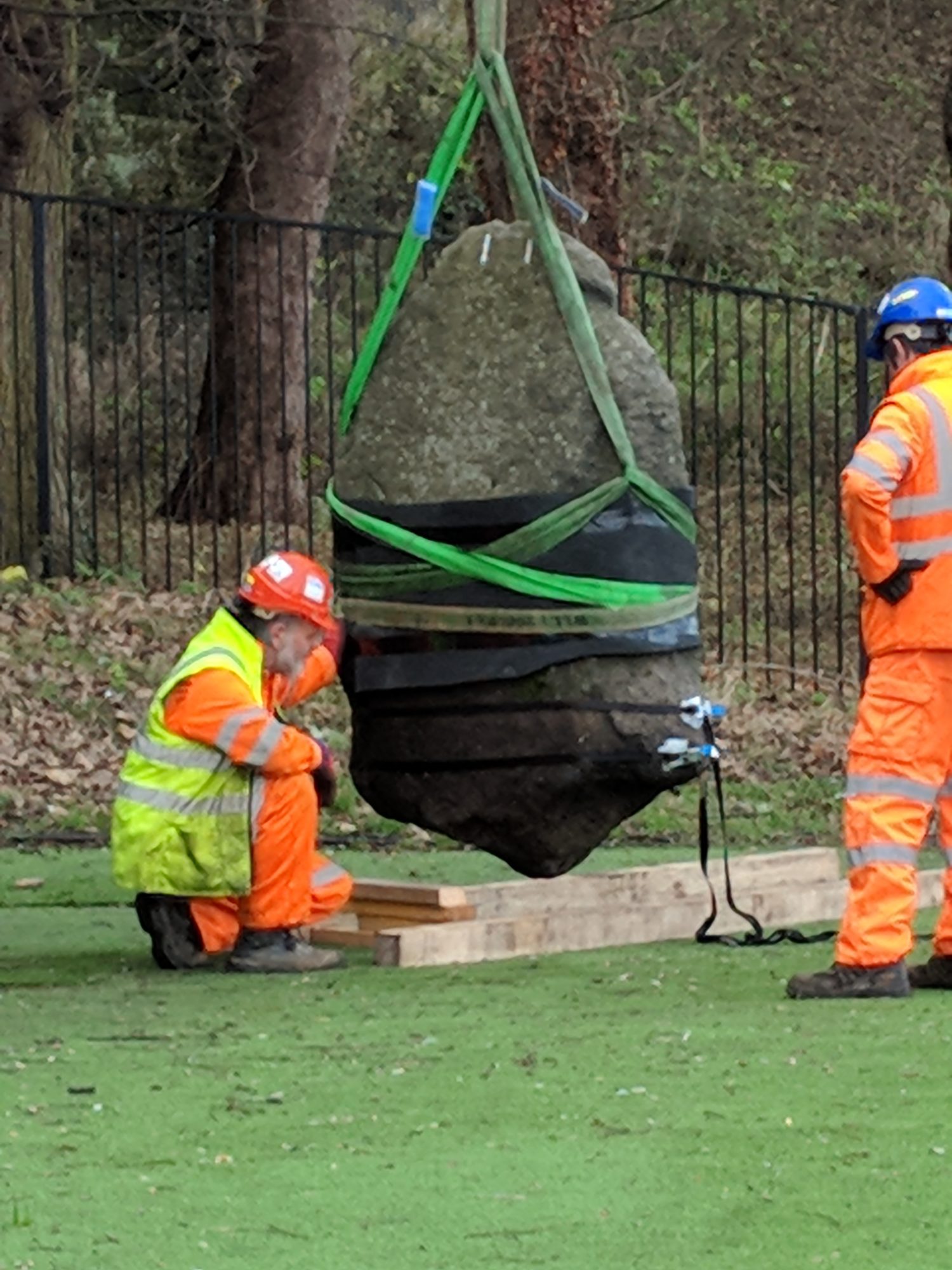 Lifting the runestone - Photo by Society of Antiquaries of Scotland